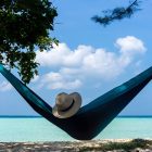 FitPro’s new Travel Insurance. Image of a hammock between two trees looking out over the ocean